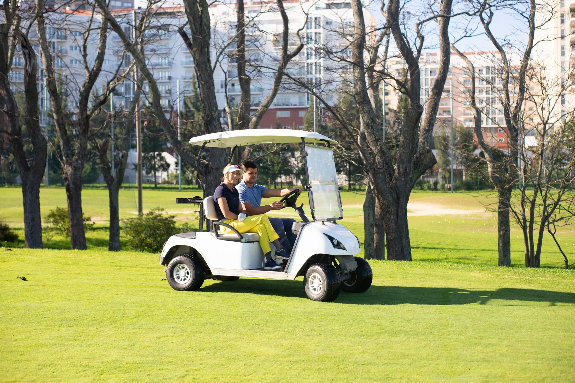 Two people riding golf cart in Ohio