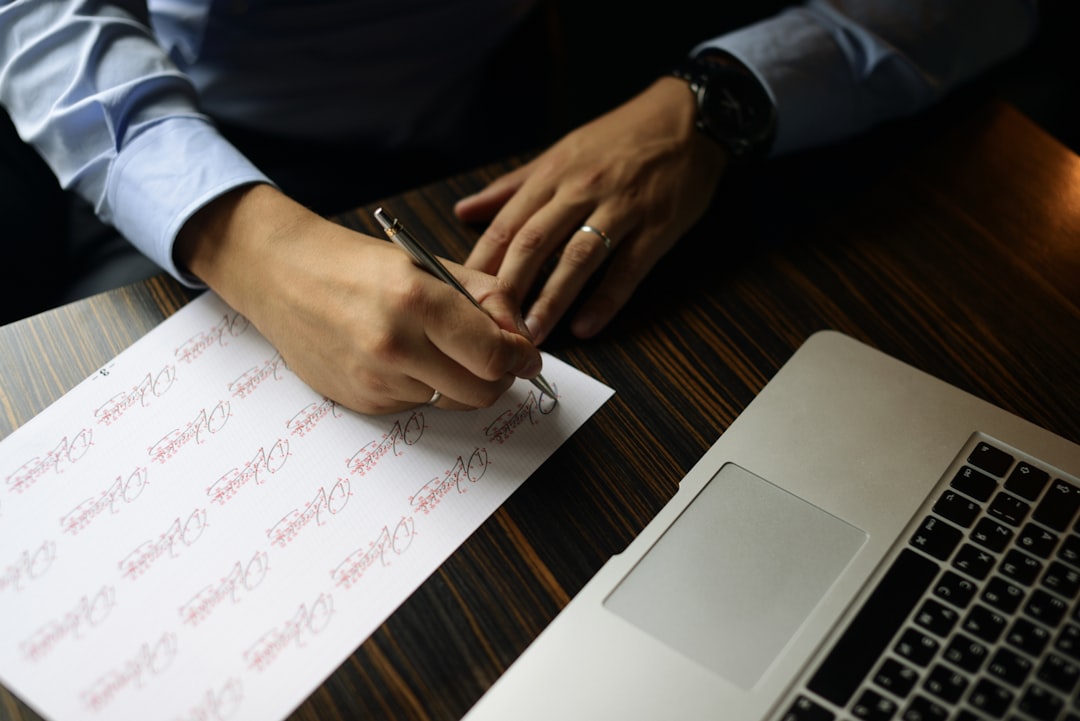 Client reviewing and signing an insurance policy document with their agent in Ohio