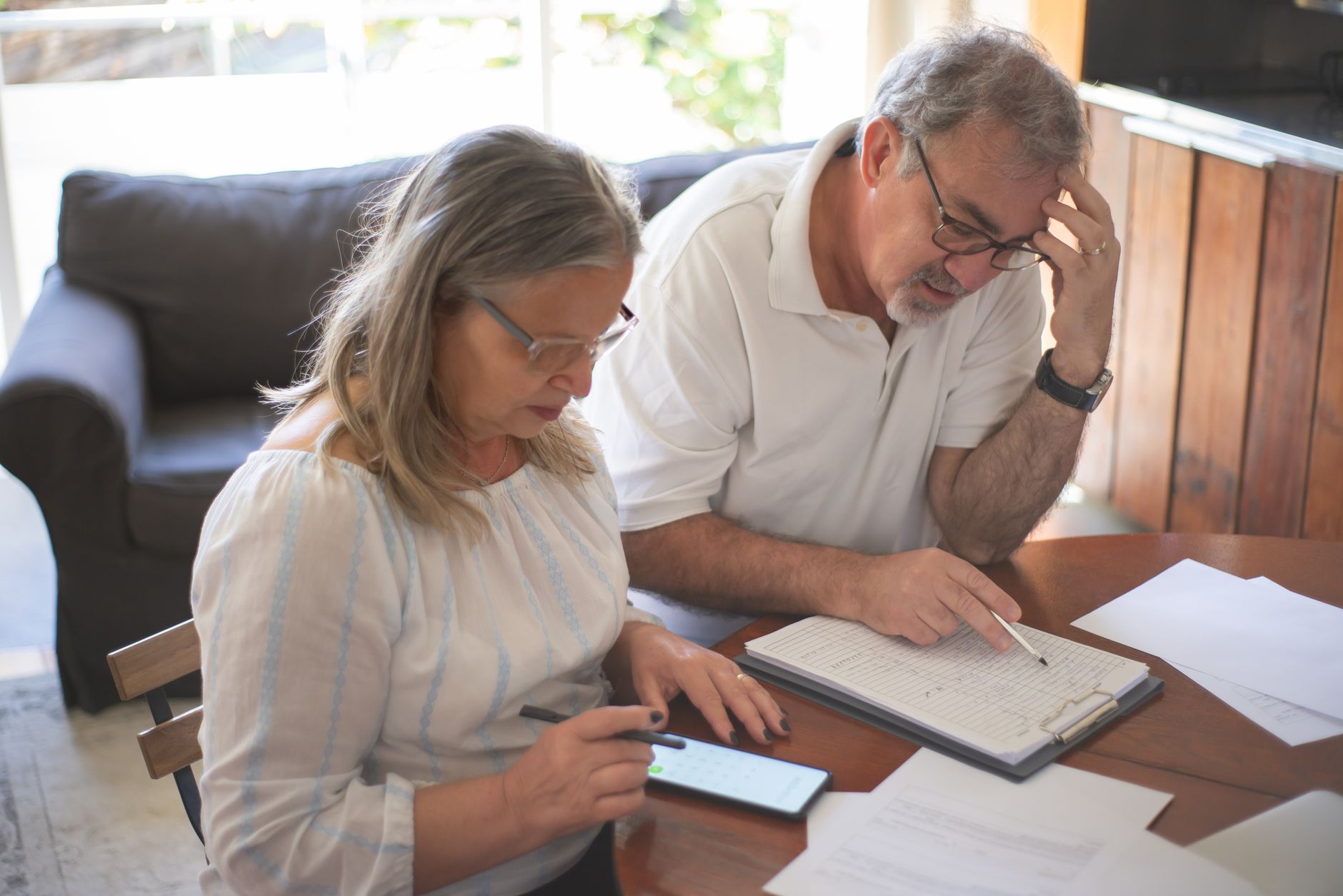 Senior person planning budget at table