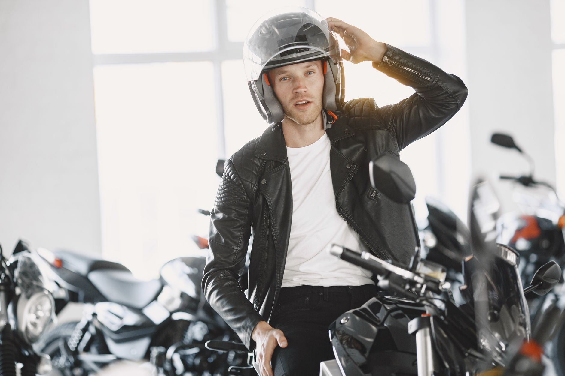 New Ohio motorcycle rider wearing safety helmet on country road