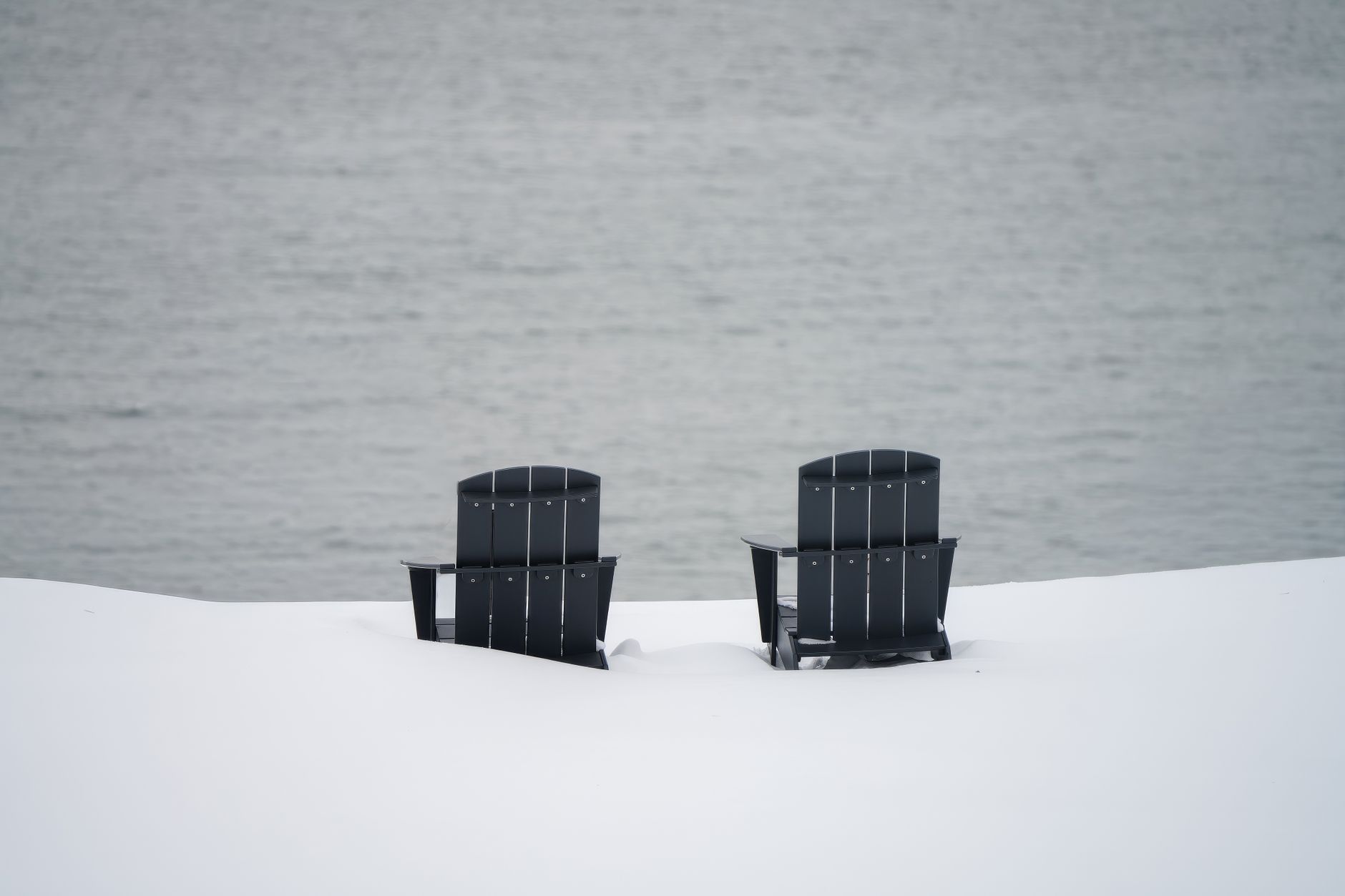 Best adirondack chair: a pair of adirondack chairs facing a lake