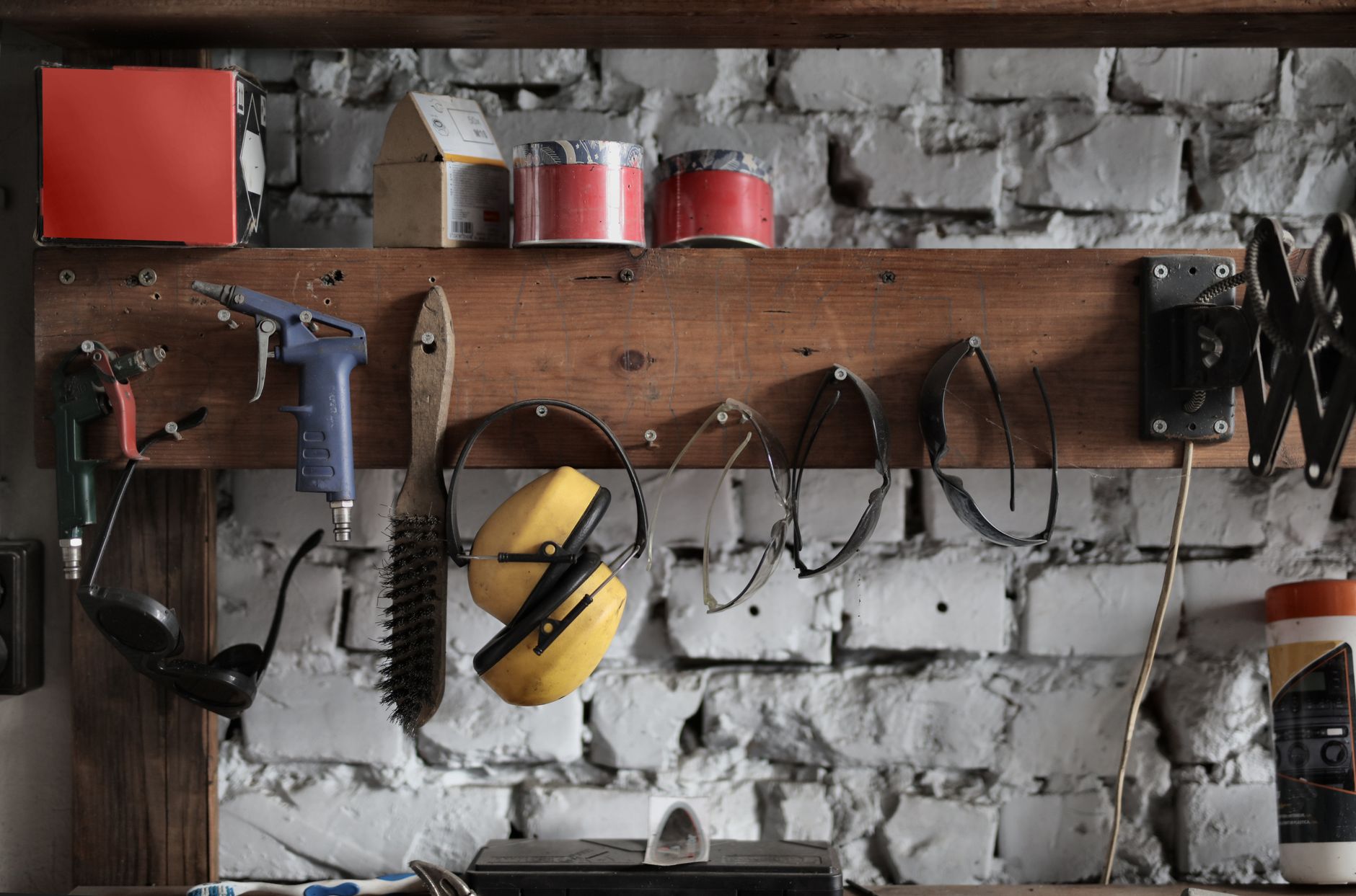 Ear protection and tools hanging on a garage wall