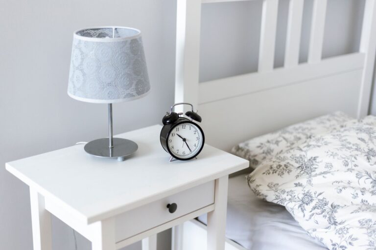 Best alarm clock: a twin-bell alarm clock on a nightstand