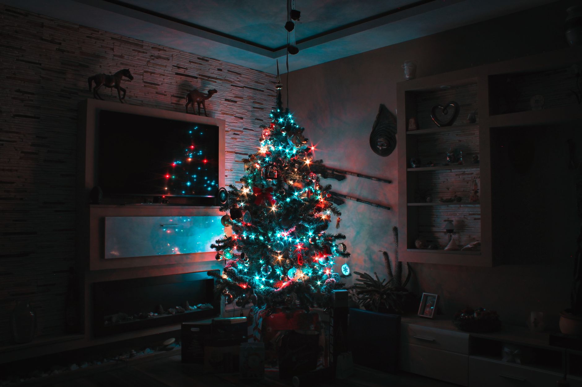 Best artificial christmas tree: a lit tree in a dim living room