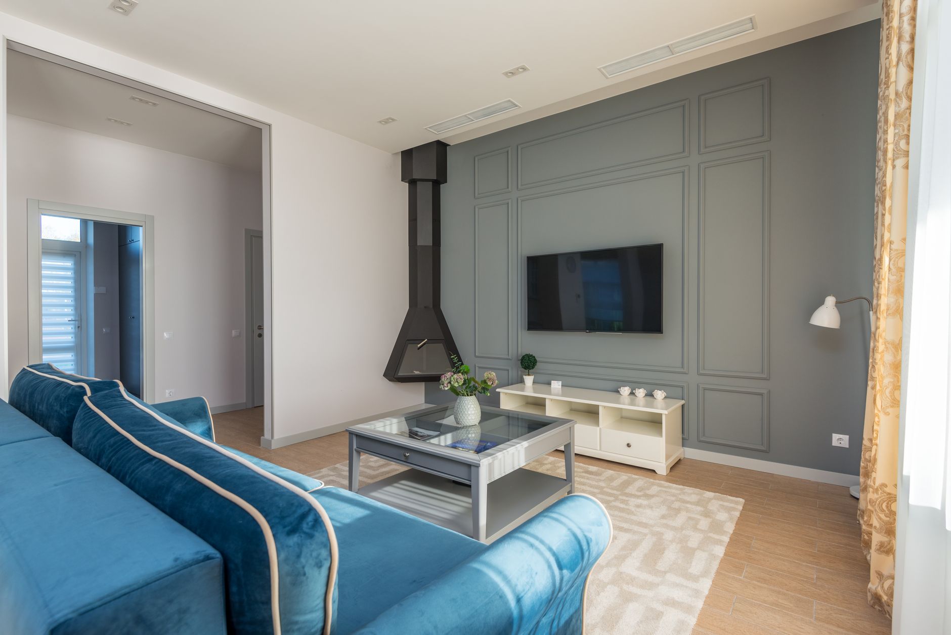 A living room with a hanging fireplace
