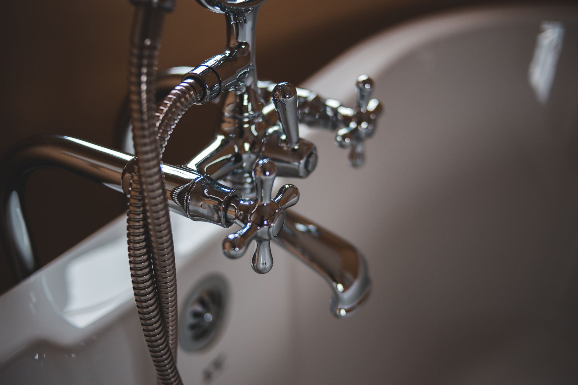 A bathtub faucet filling a tub with water