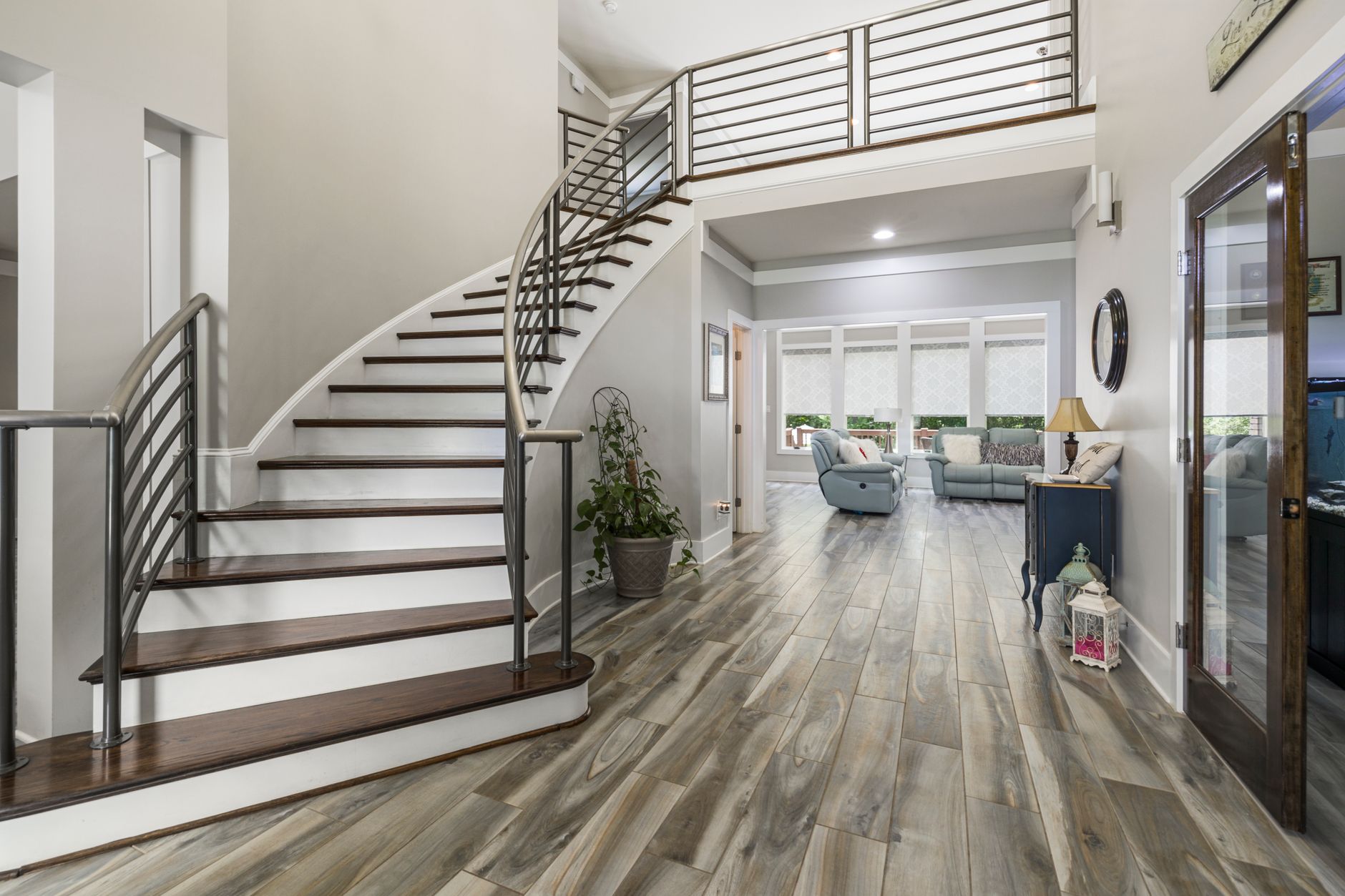 A curved staircase in an open entry hall