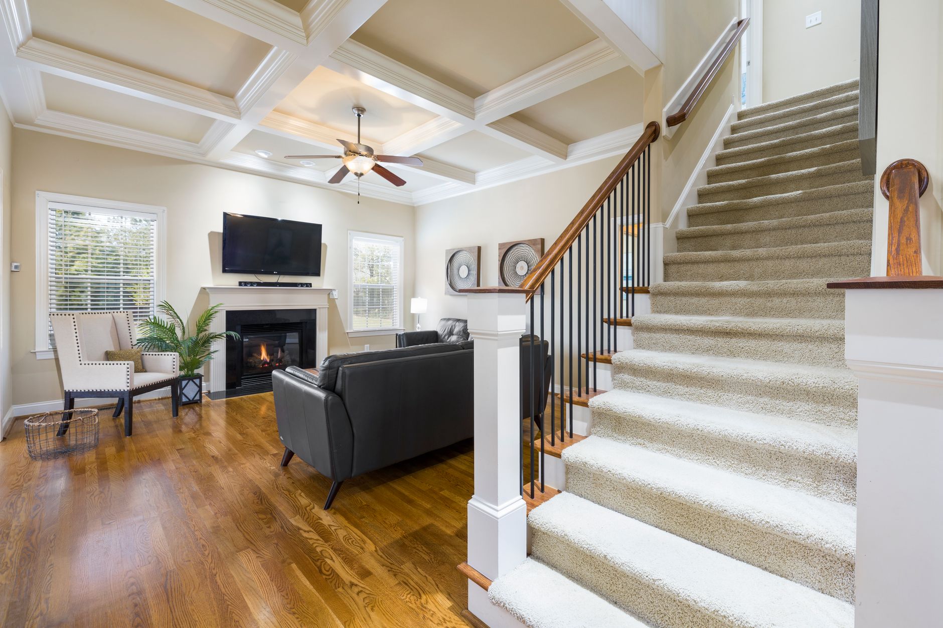 A carpeted staircase beside a living room
