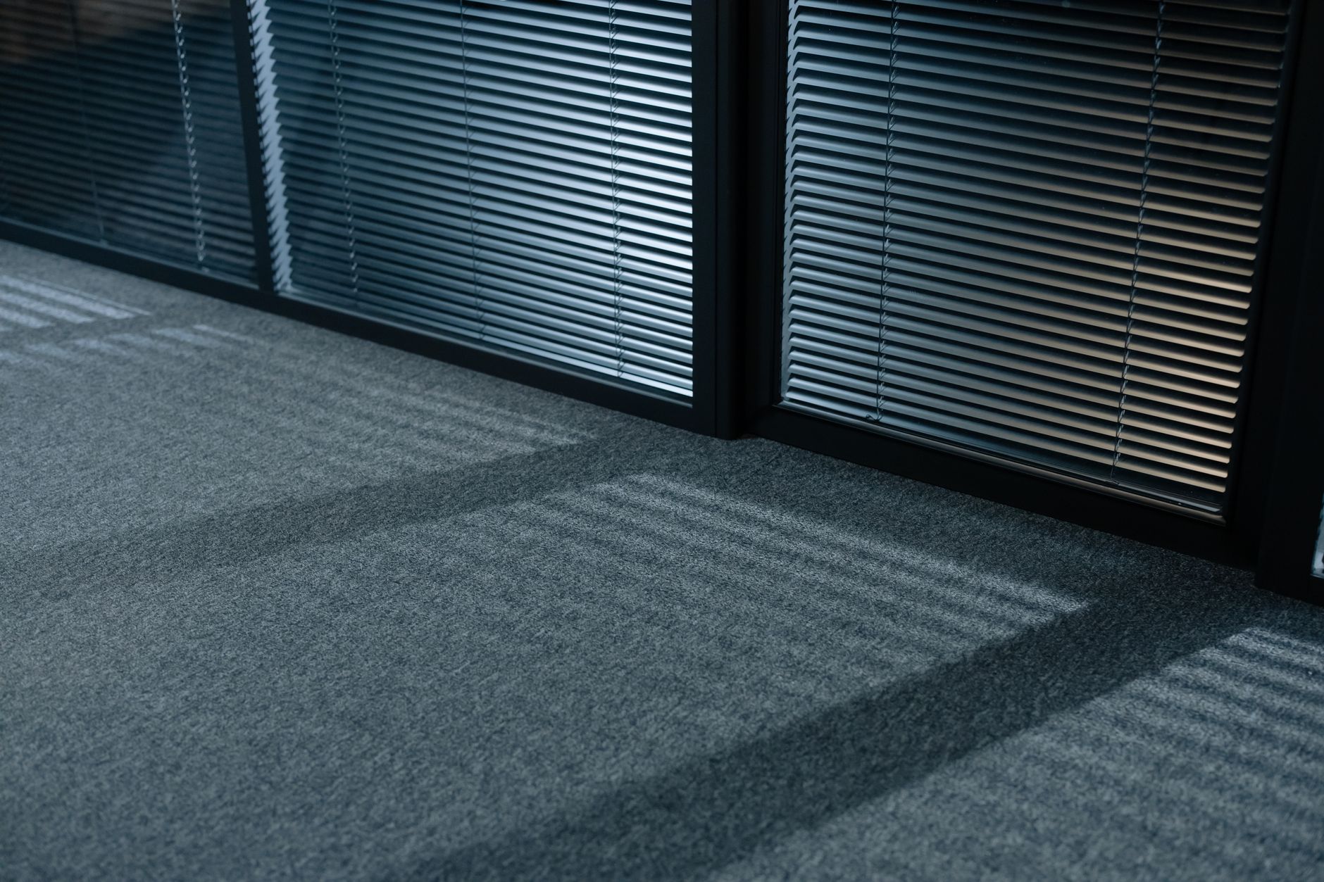 Carpet in an office by glass partitions