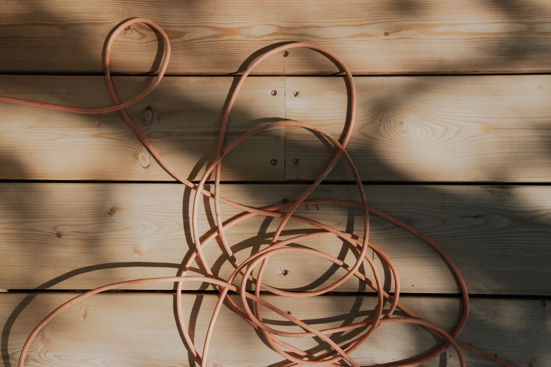 A coiled extension cord on wood