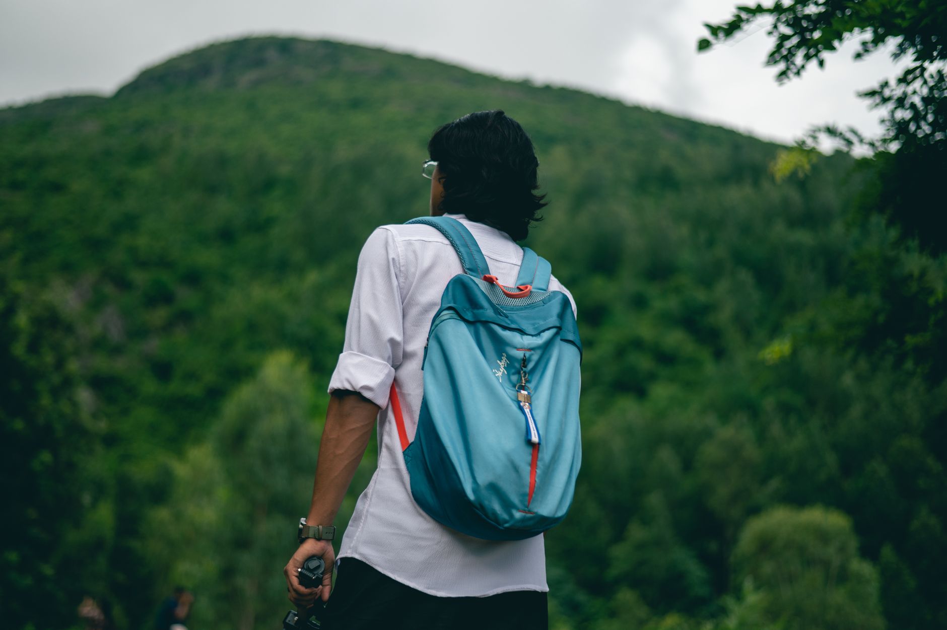 A hiker with a backpack on a trail