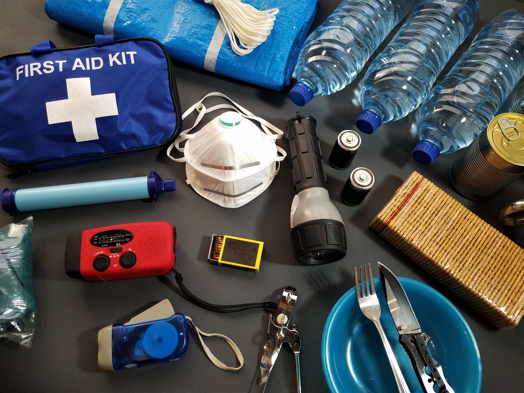 An emergency kit with water bottles and a first aid kit
