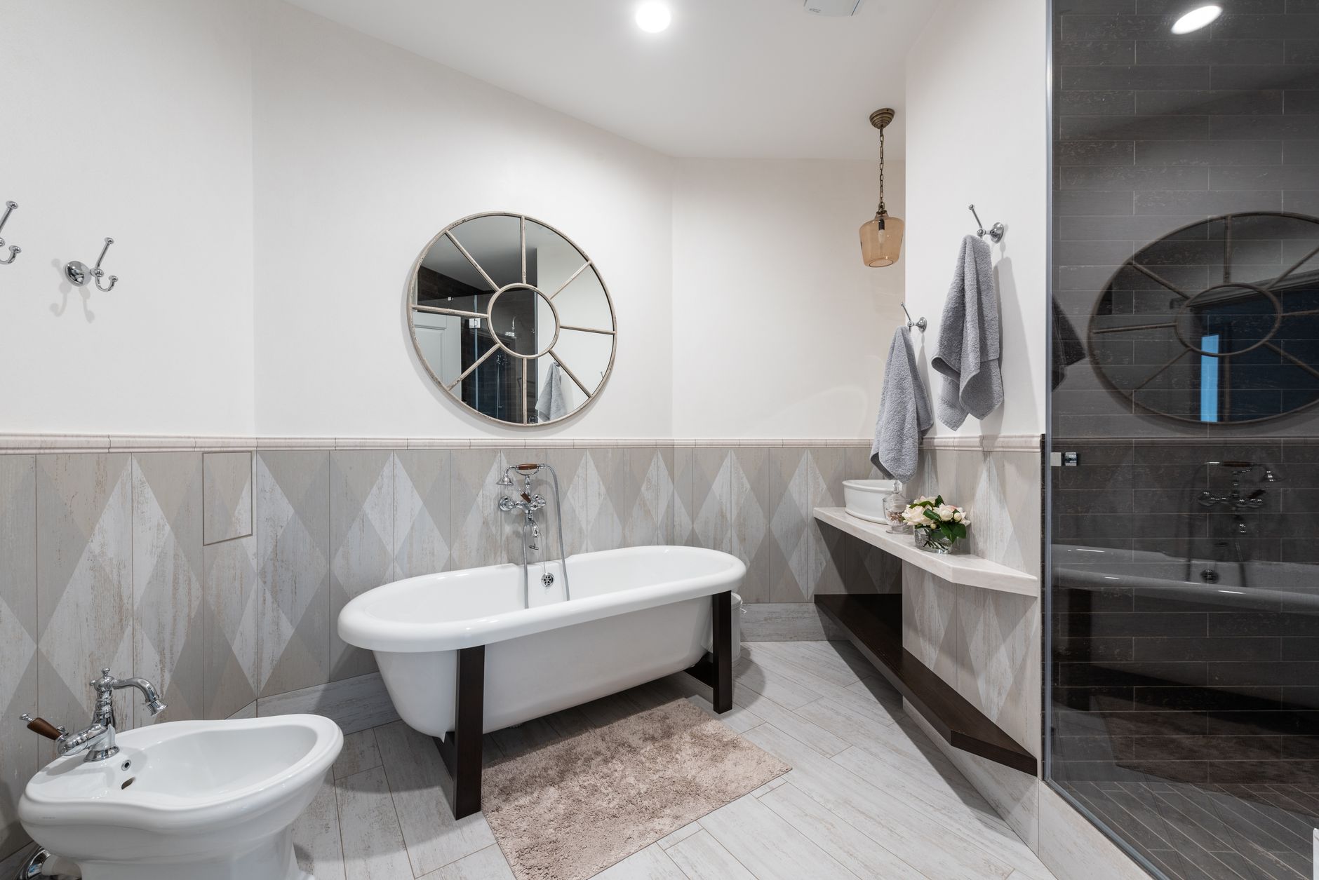 Best bath rug: a rug beside a freestanding tub in a gray bathroom