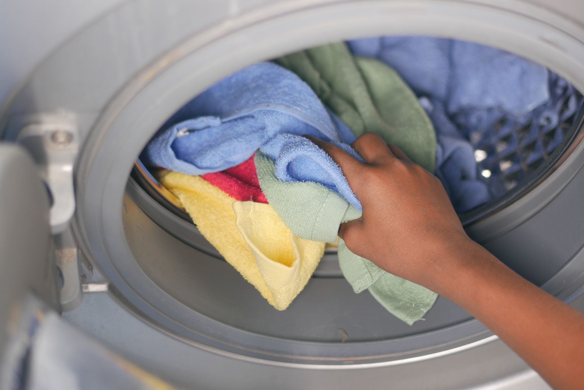 Loading towels into a washing machine