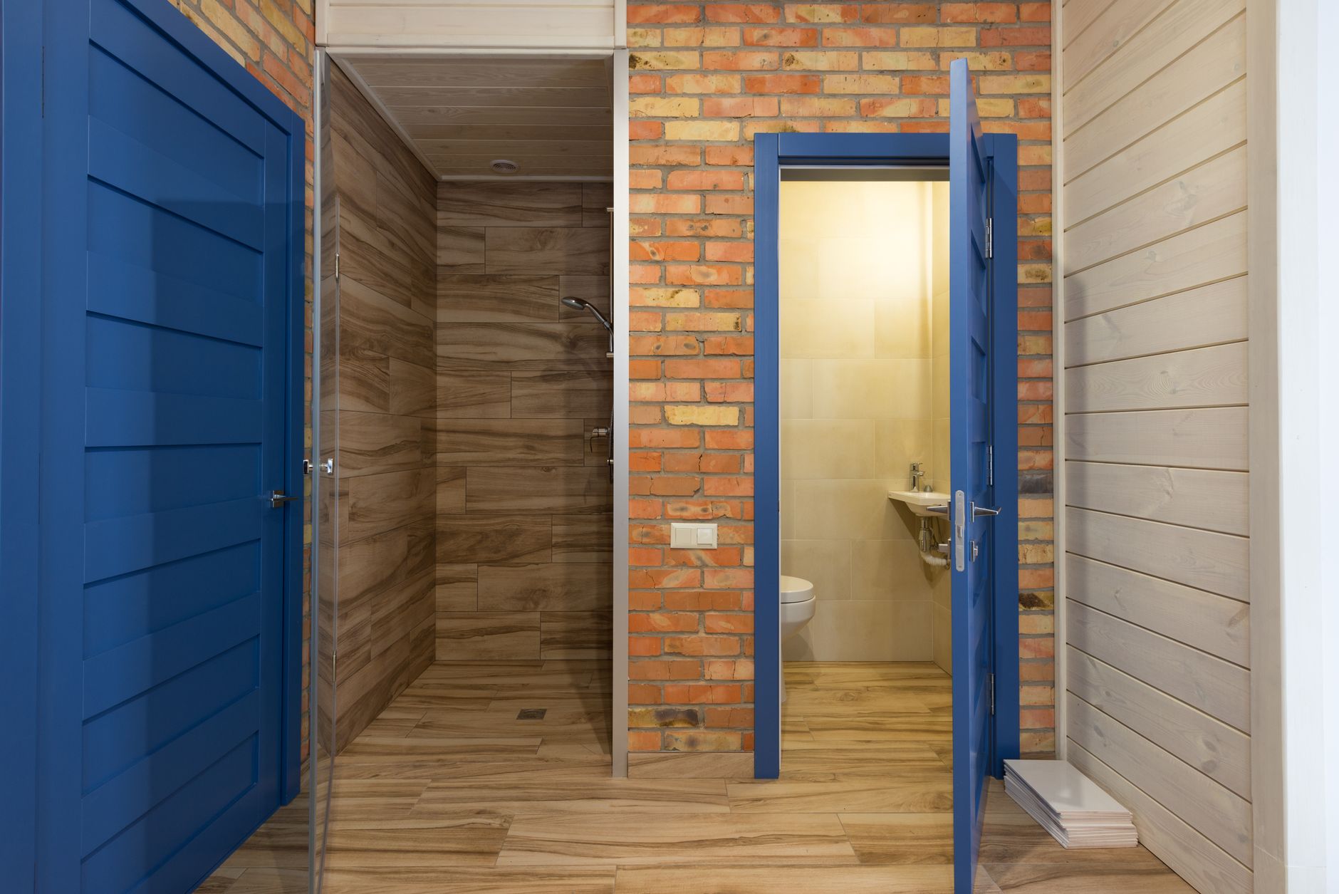A small bathroom seen through blue doors