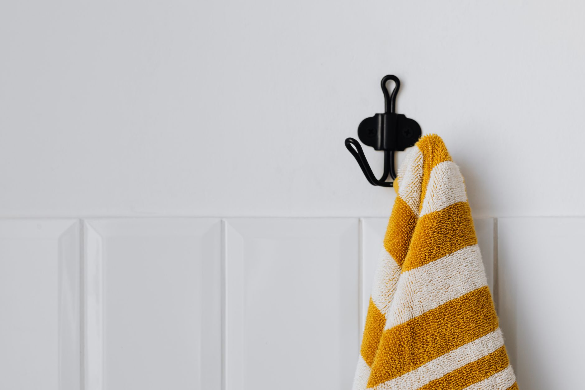 A striped towel on a wall hook