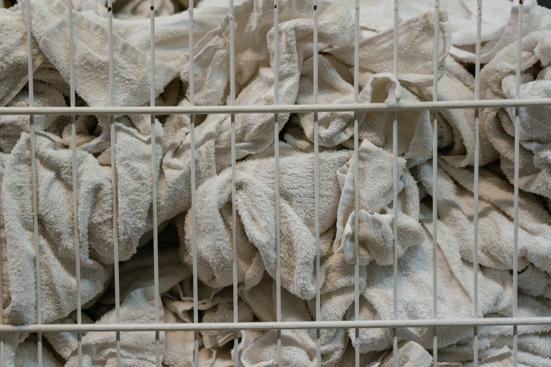 Used towels in a wire laundry bin