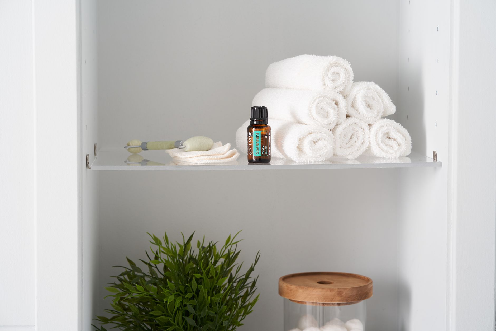 Best bathroom shelf: folded towels and toiletries on a bathroom shelf