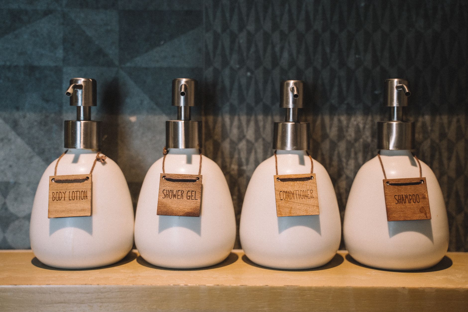 Labeled soap dispensers on a shelf