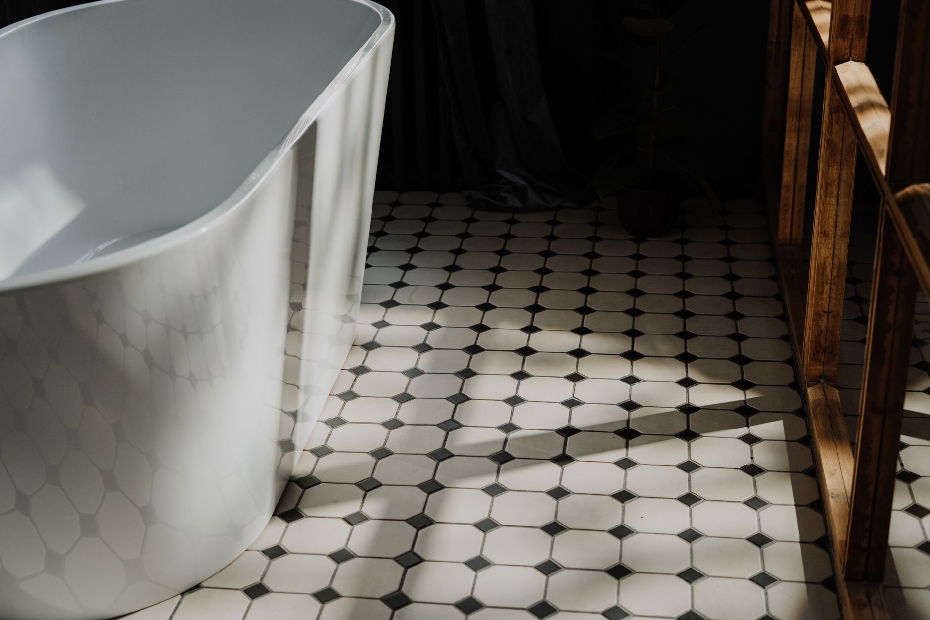 A freestanding tub on a tiled floor