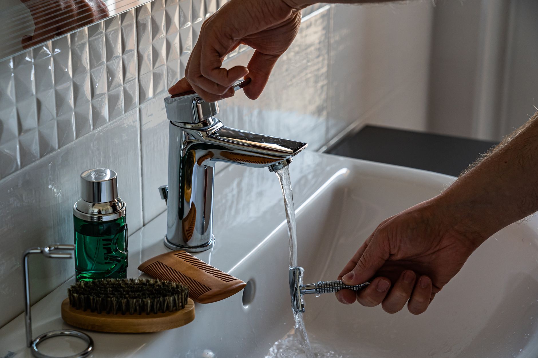 Rinsing a razor at a bathroom sink