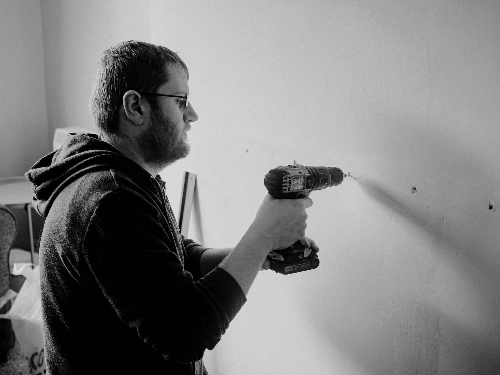 A man drilling into a wall