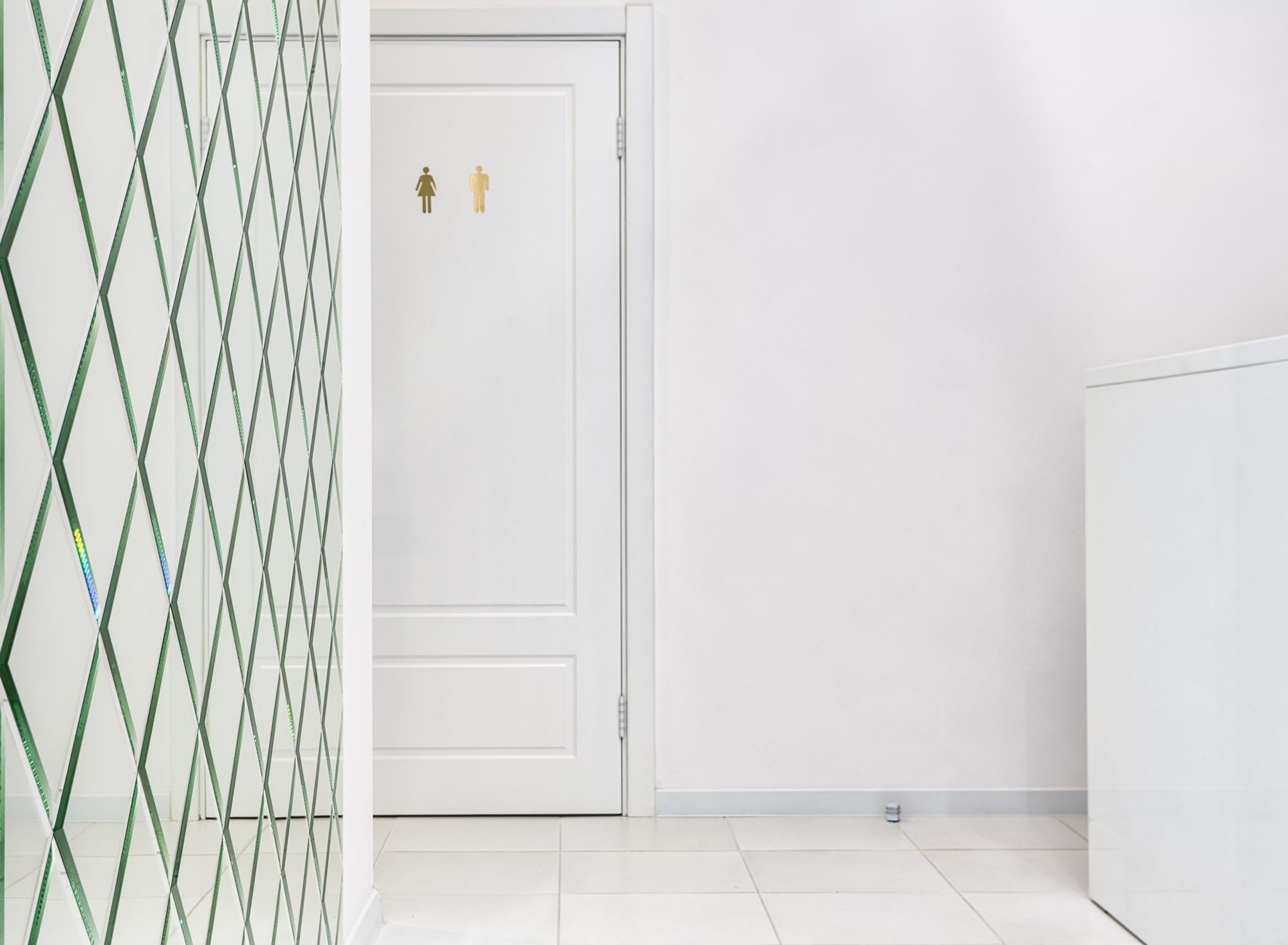 A bright bathroom with a tiled wall