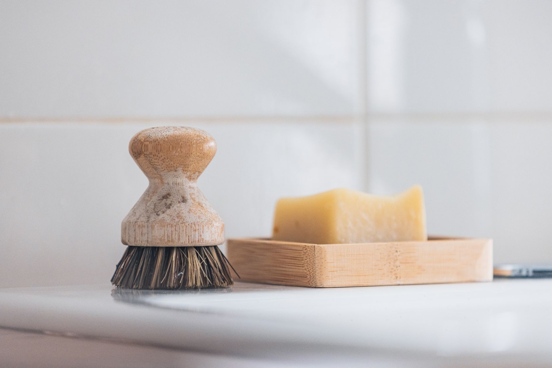 A scrub brush and soap on a sink