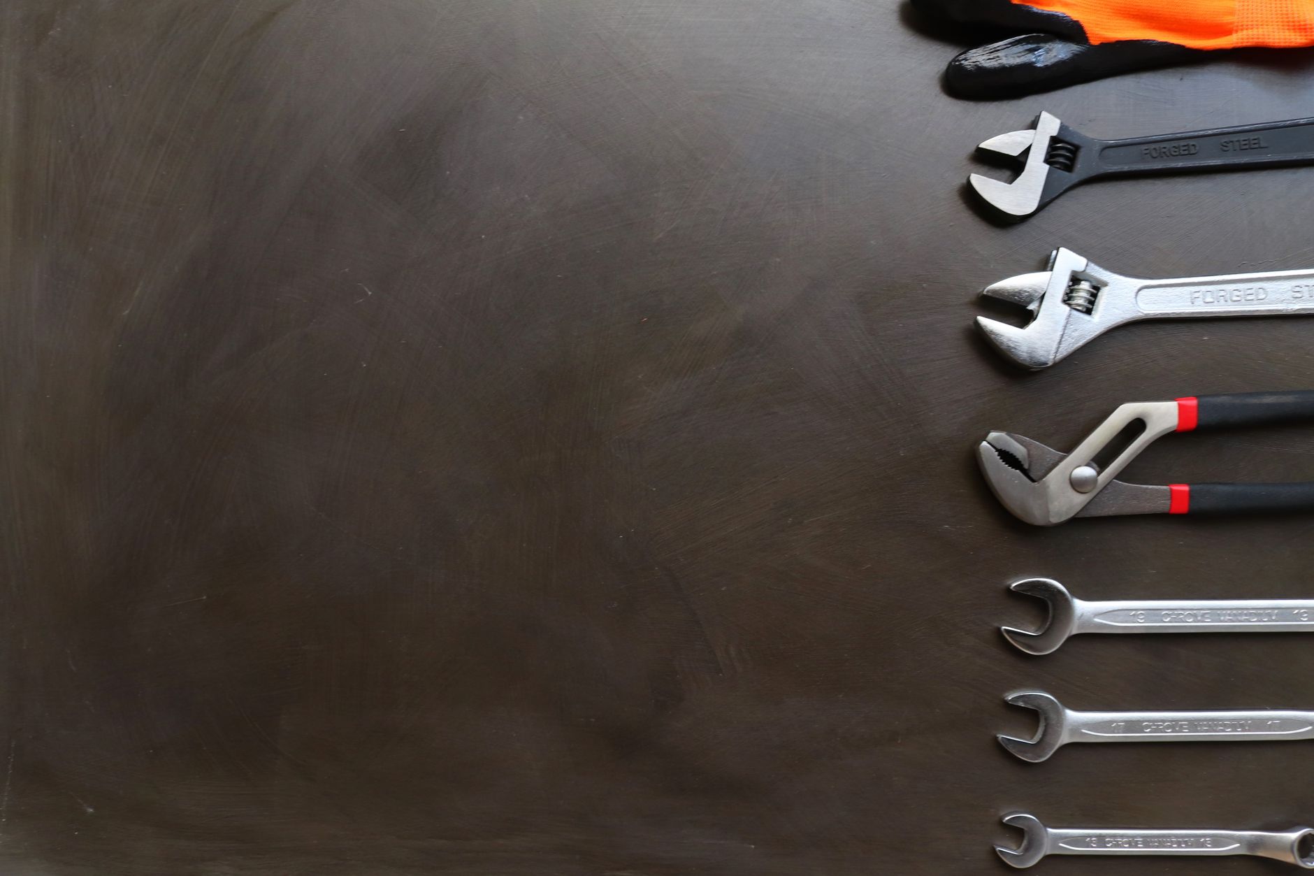 Wrenches laid out on a dark surface