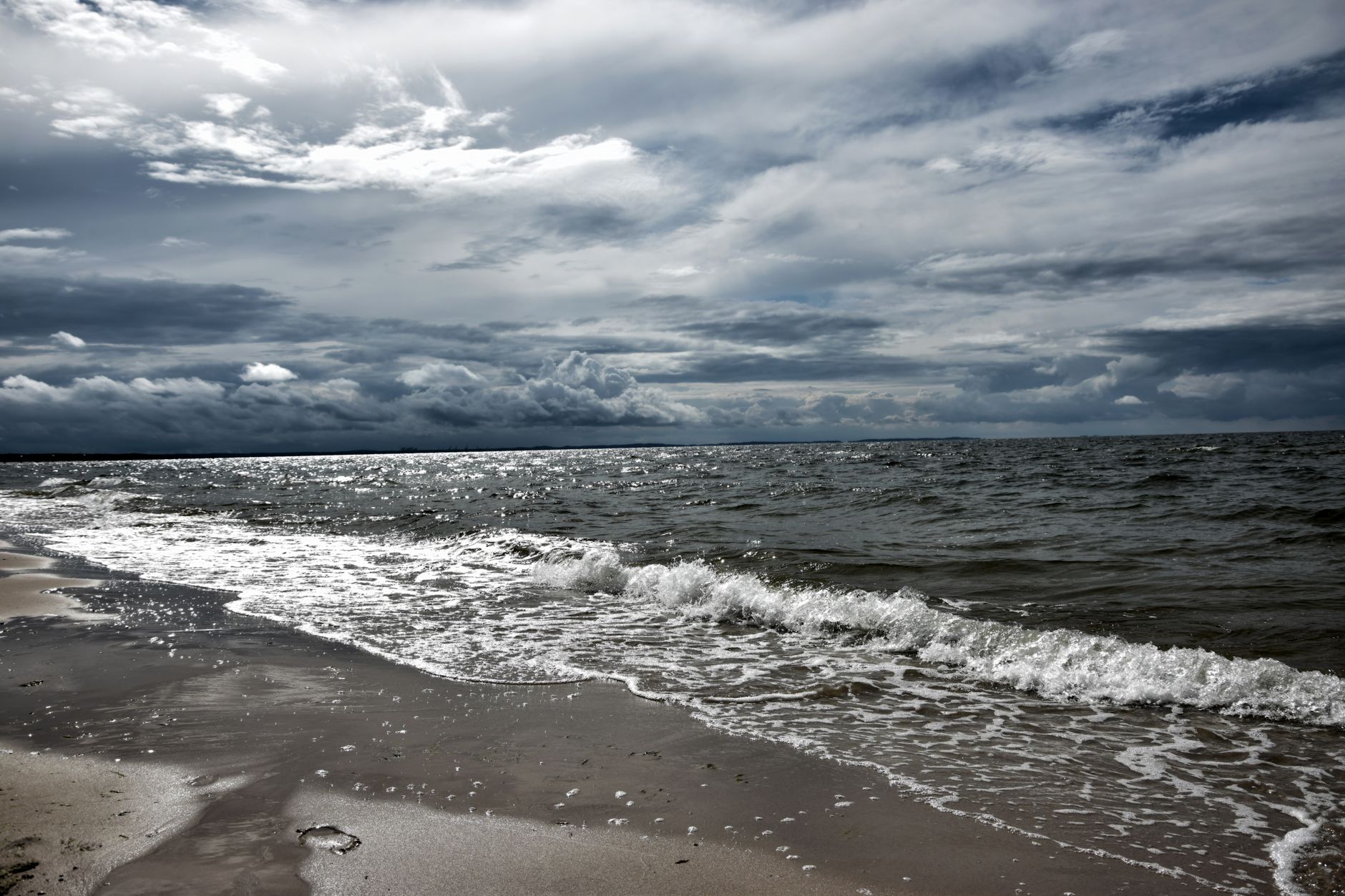 Waves rolling onto a breezy beach
