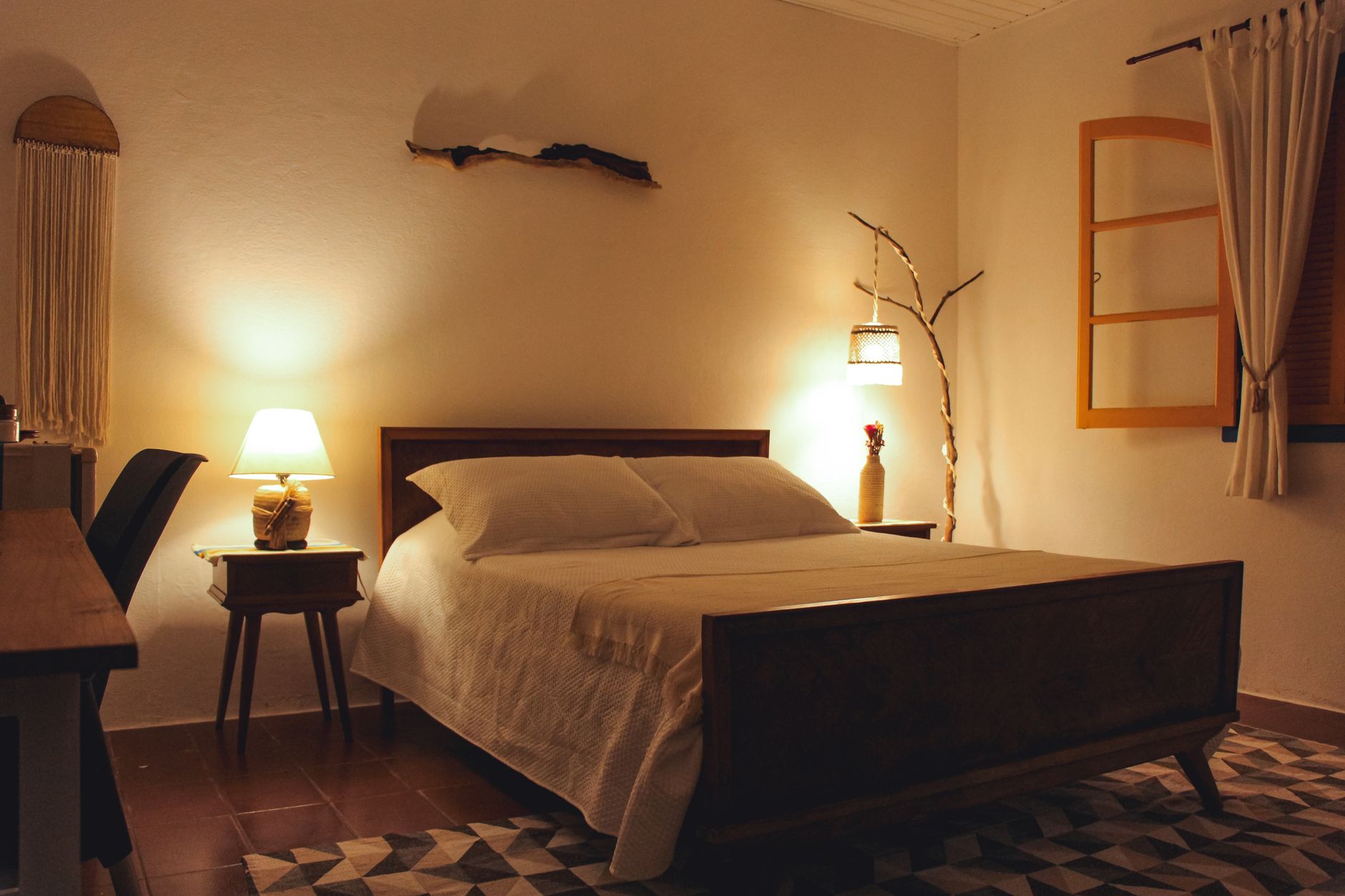 A bedroom lit by bedside lamps