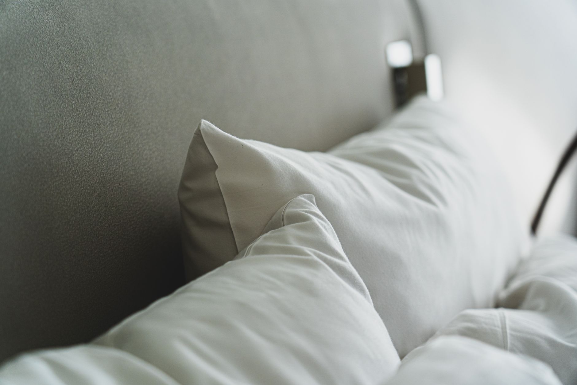 White pillows against a gray headboard