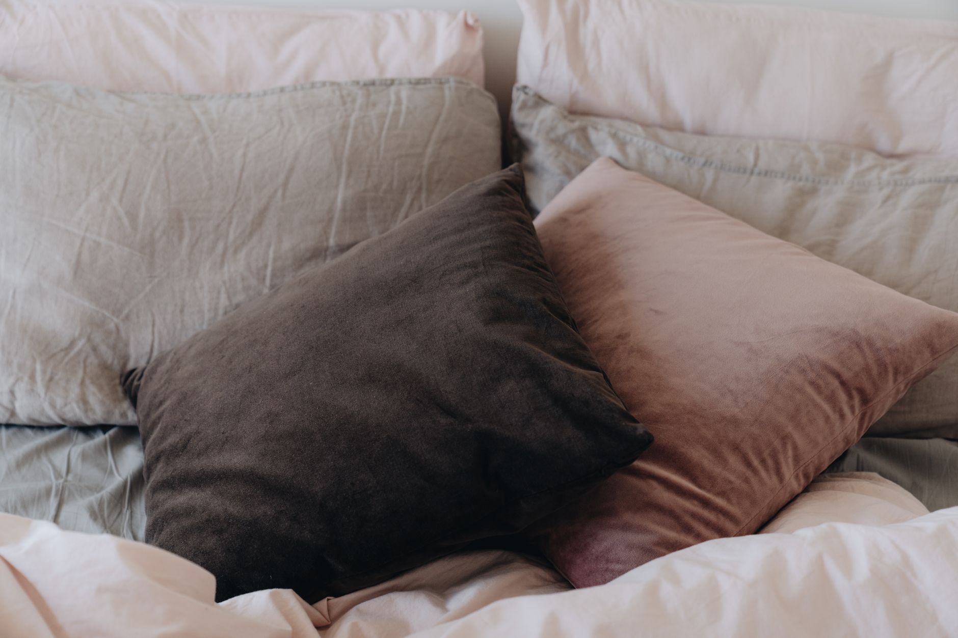 Velvet throw pillows on a bed