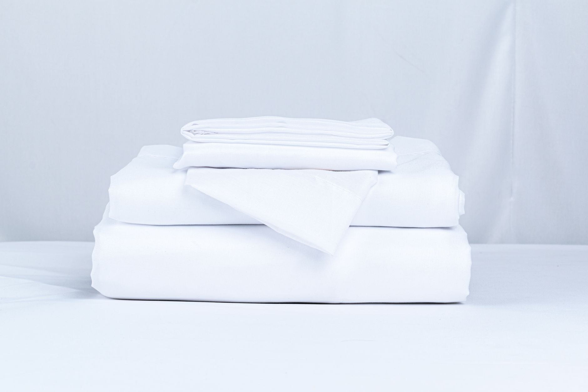 A stack of folded white sheets