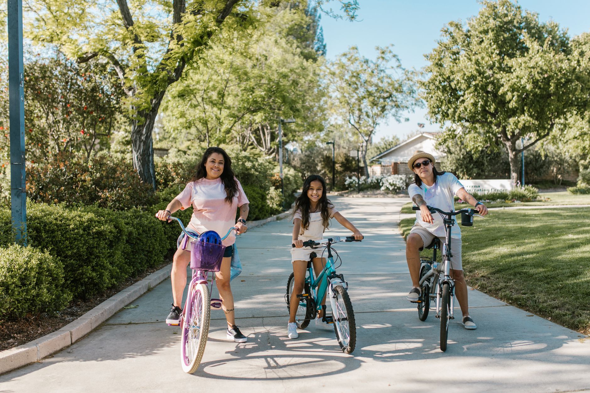 A family riding bikes together on a park path