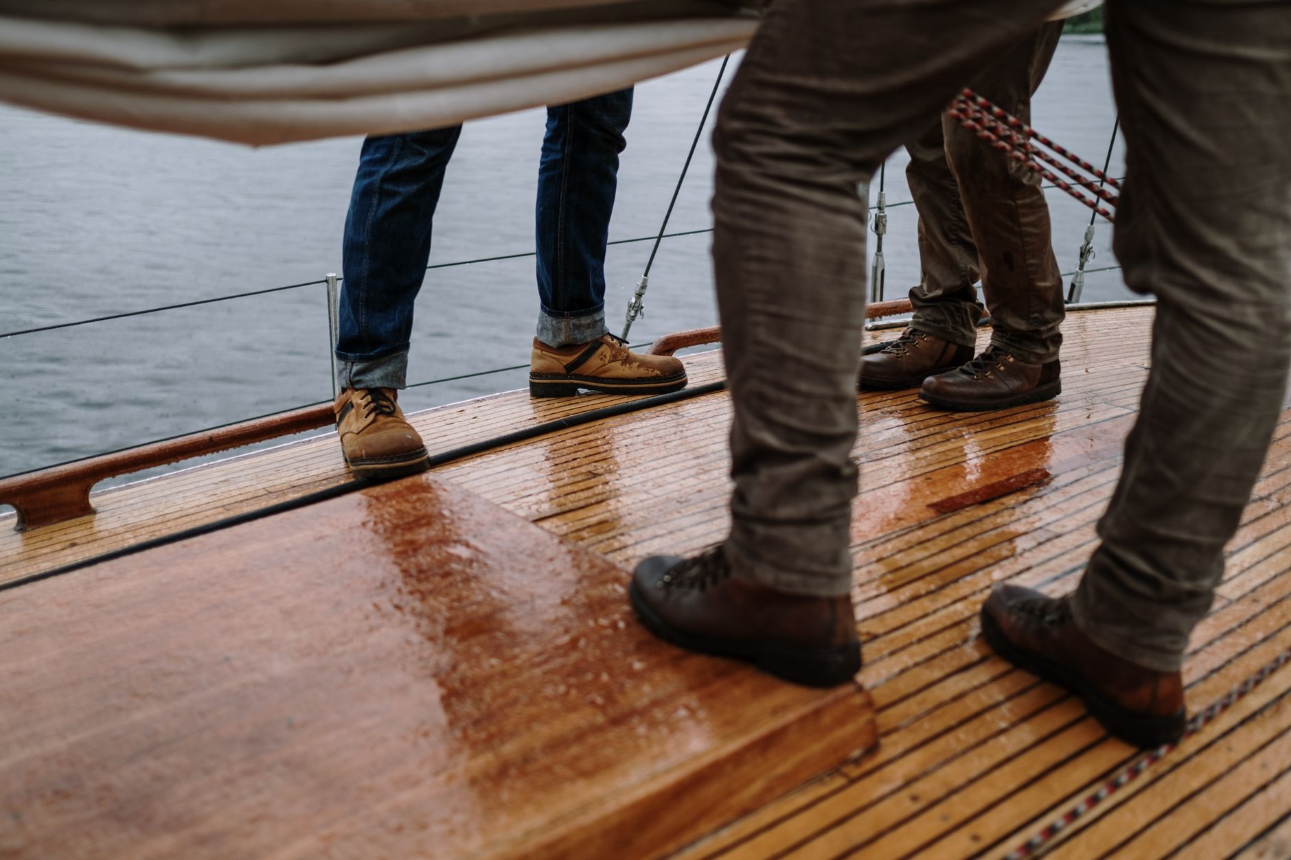 Boots on a wet wooden boat deck