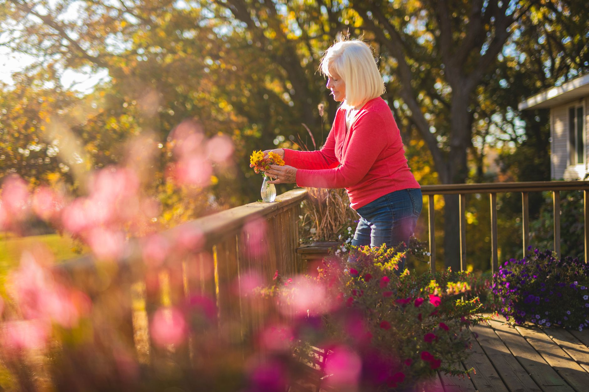 A backyard deck railing overlooking a garden