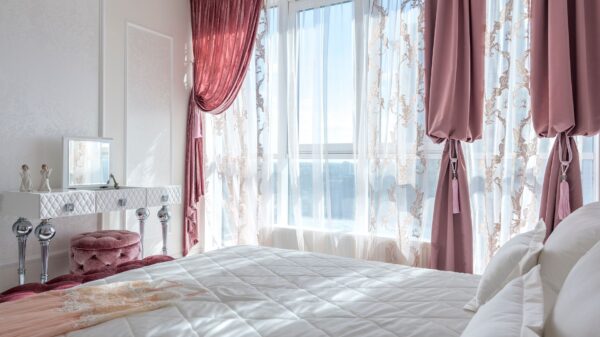 Best blackout curtains: pink drapes over sheer curtains in a bedroom