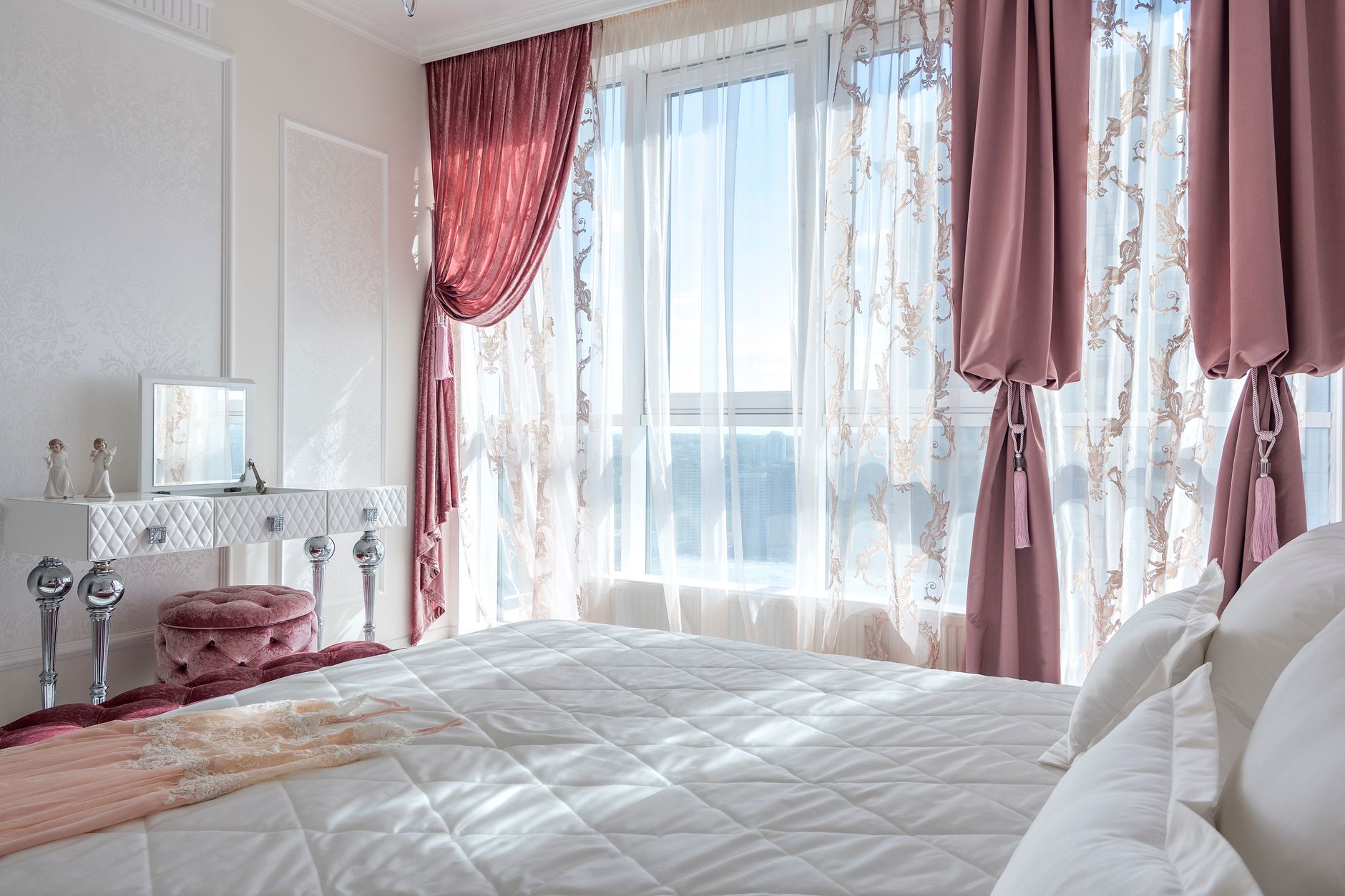 Best blackout curtains: pink drapes over sheer curtains in a bedroom