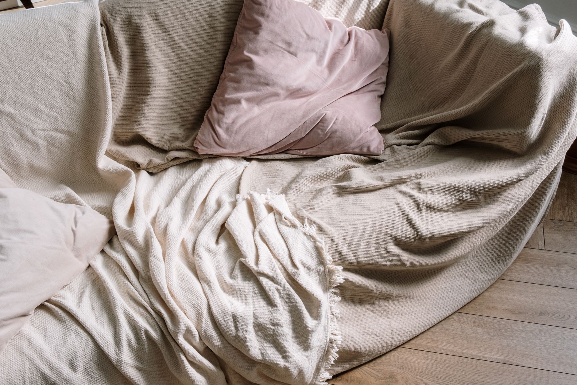 A folded throw blanket on a sofa