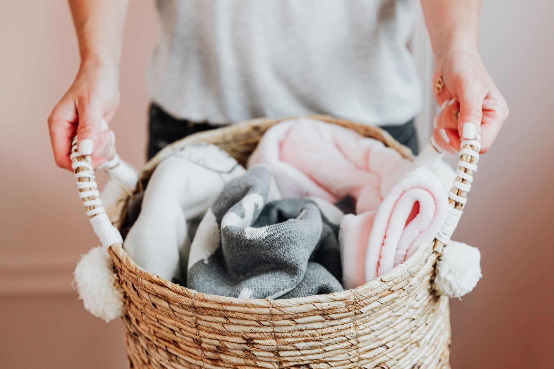 A woven basket holding blankets