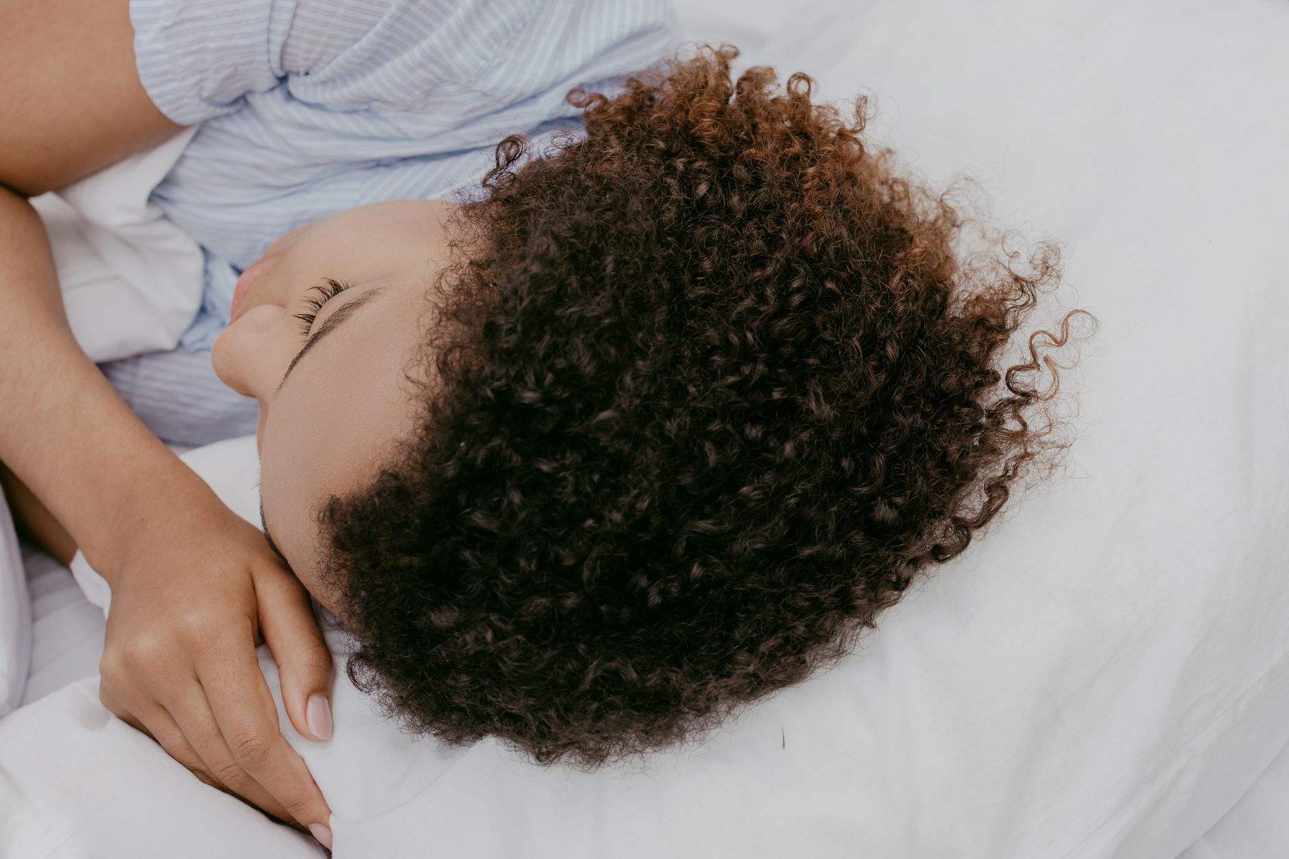 A person asleep on their side in bed