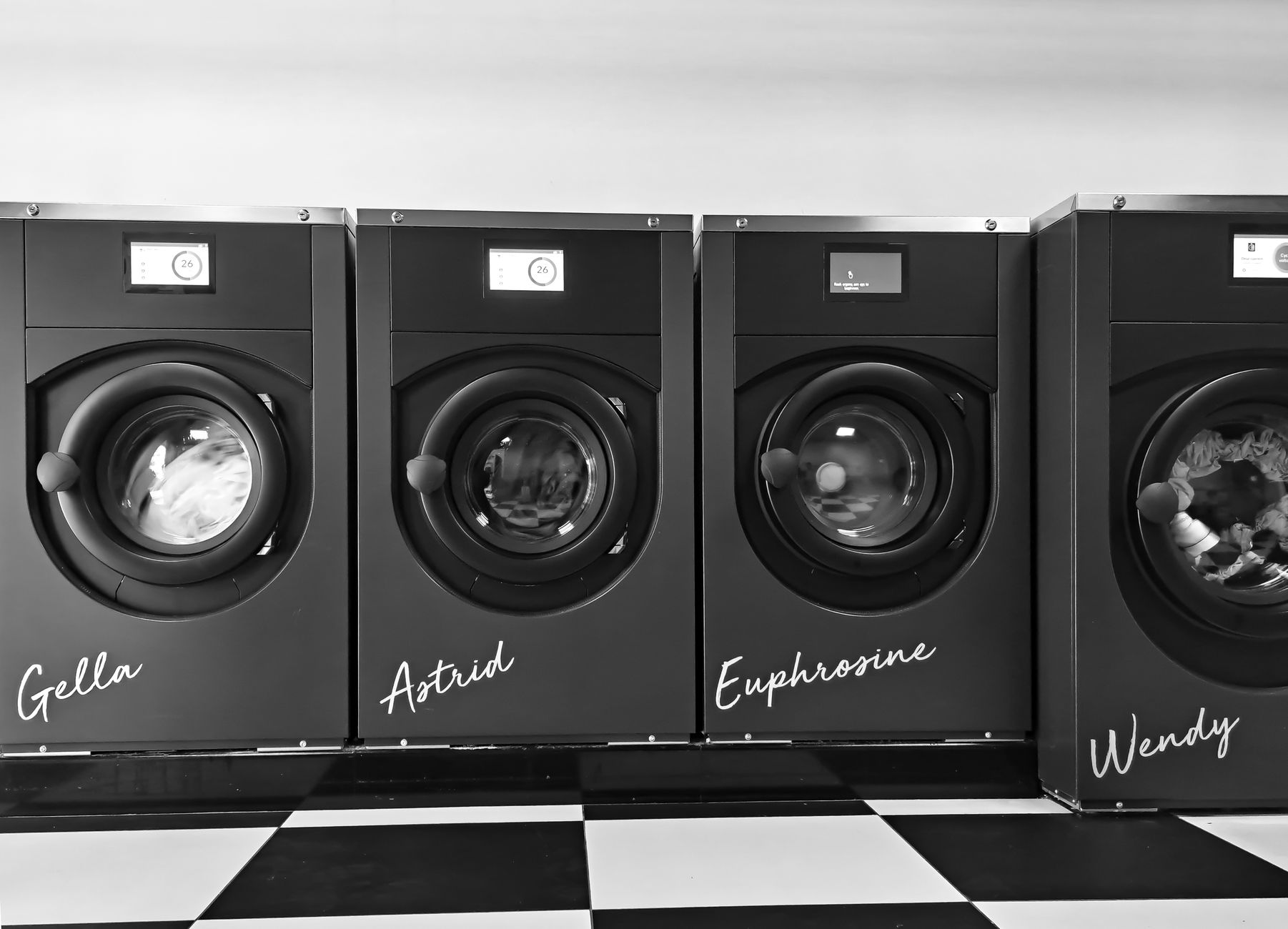 Laundry being loaded into a washing machine