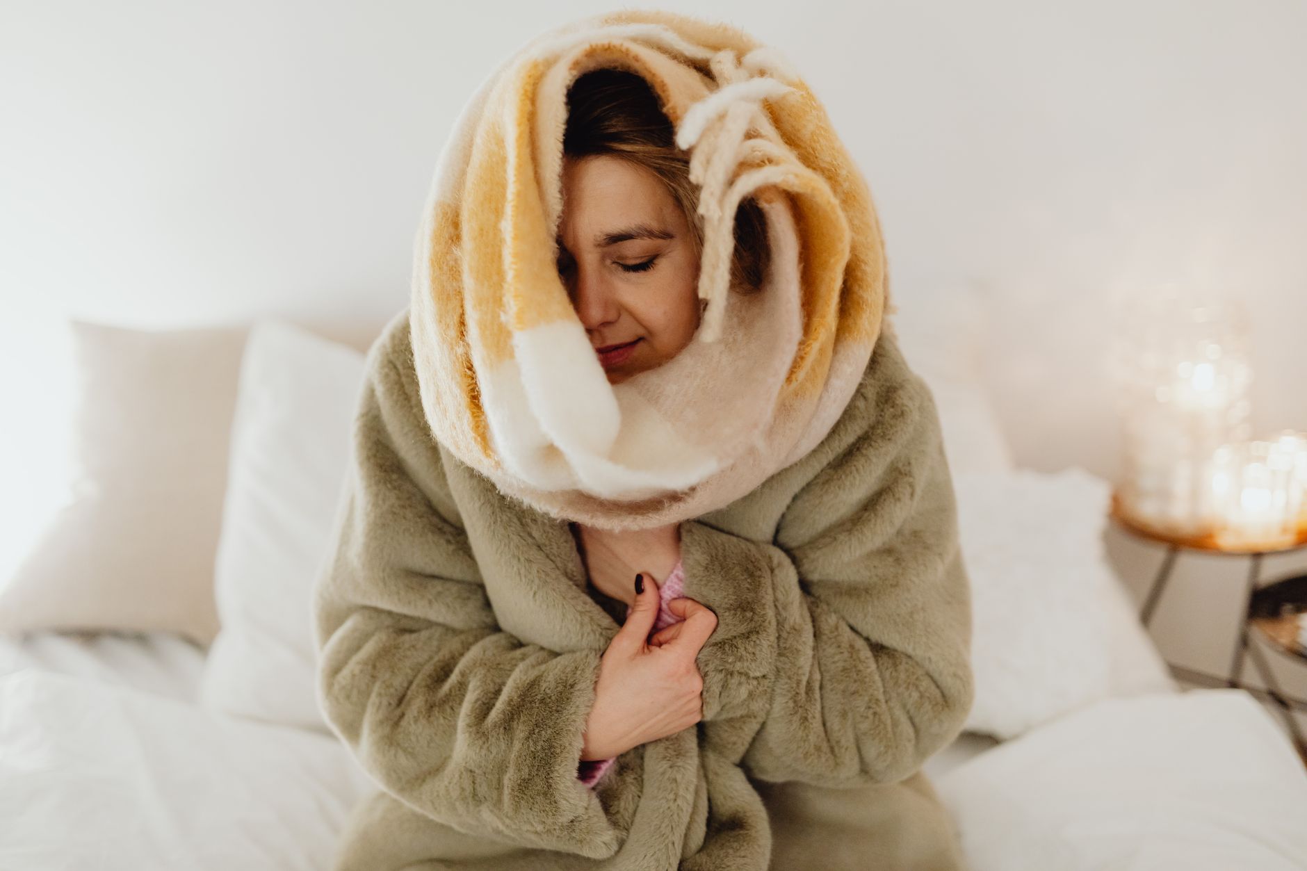 A cozy bedroom with a warm blanket on the bed