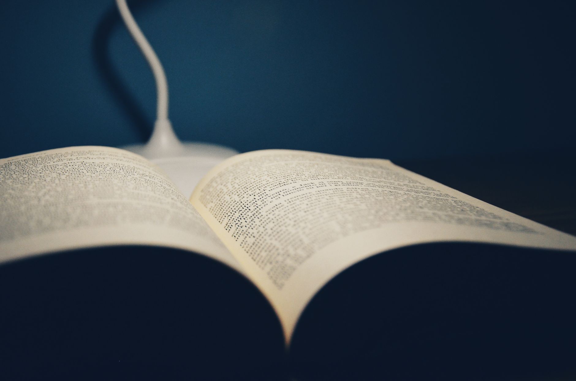 An open book lit by a warm light at night