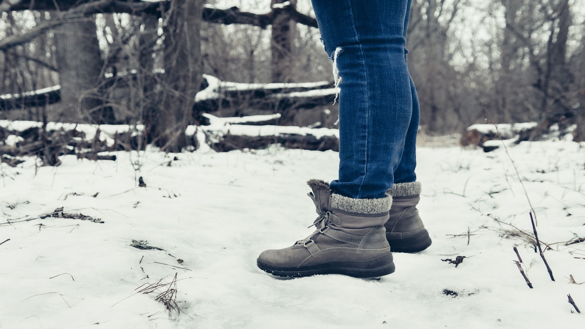 Snow-covered boots on a floor