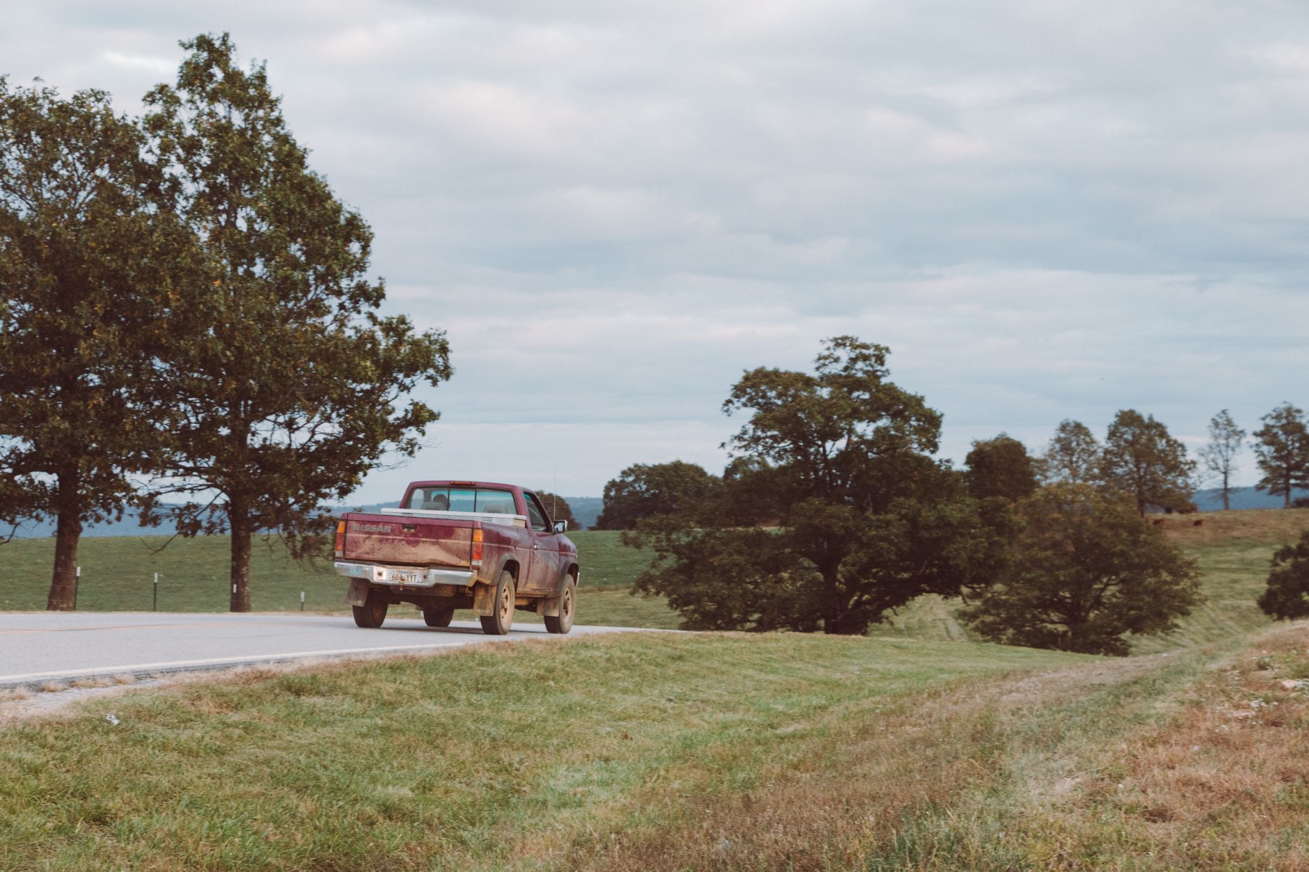 A pickup truck driving on a rural road