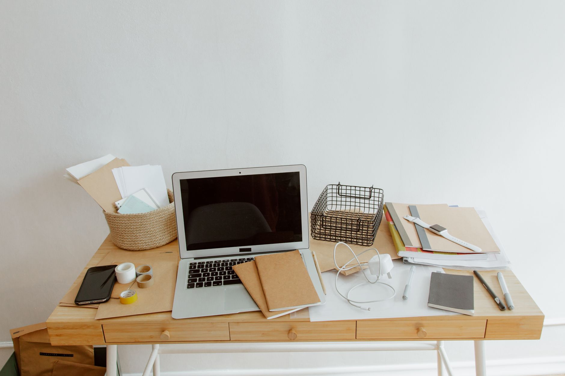 Best cable management: a laptop and supplies on a small wooden desk