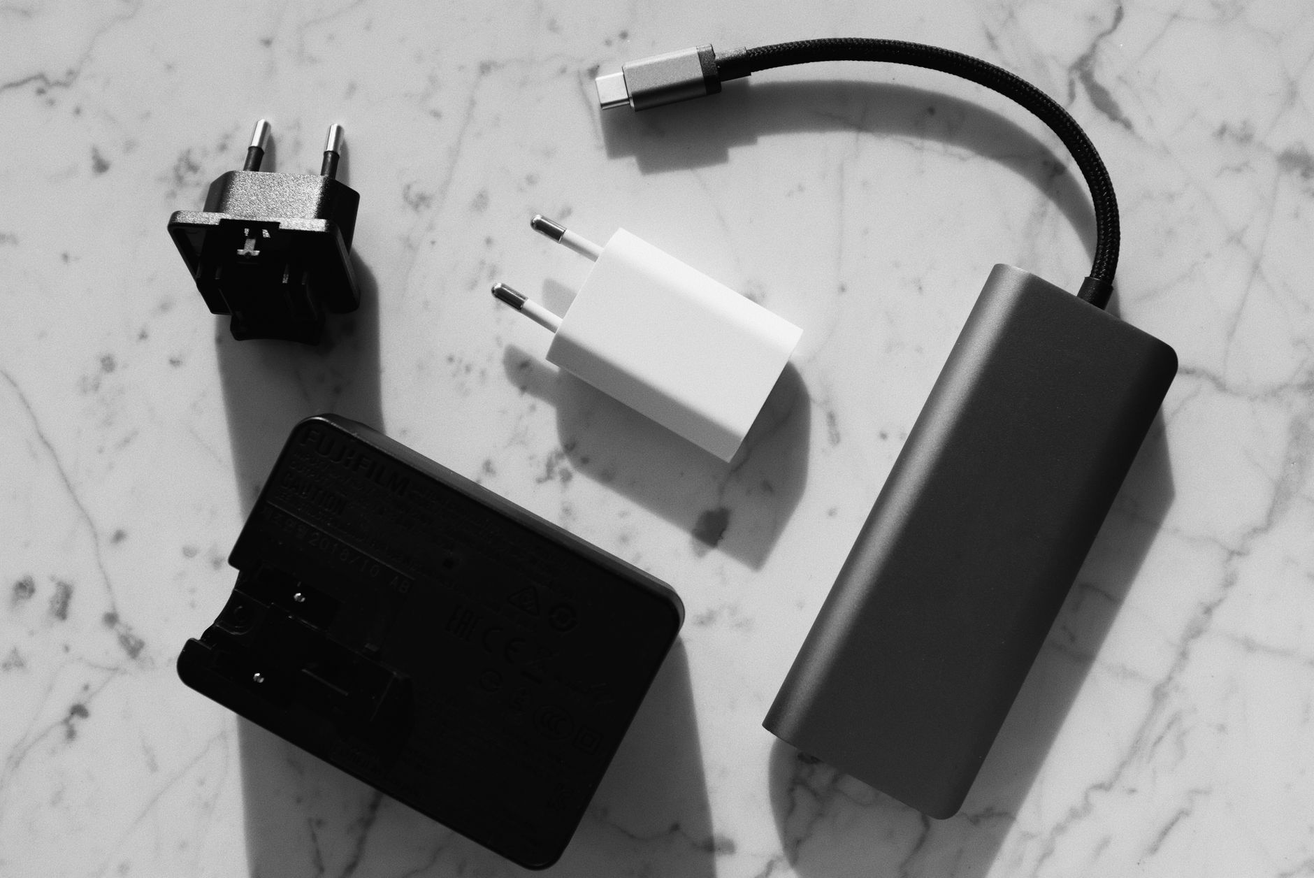 Chargers and a USB hub on a marble surface