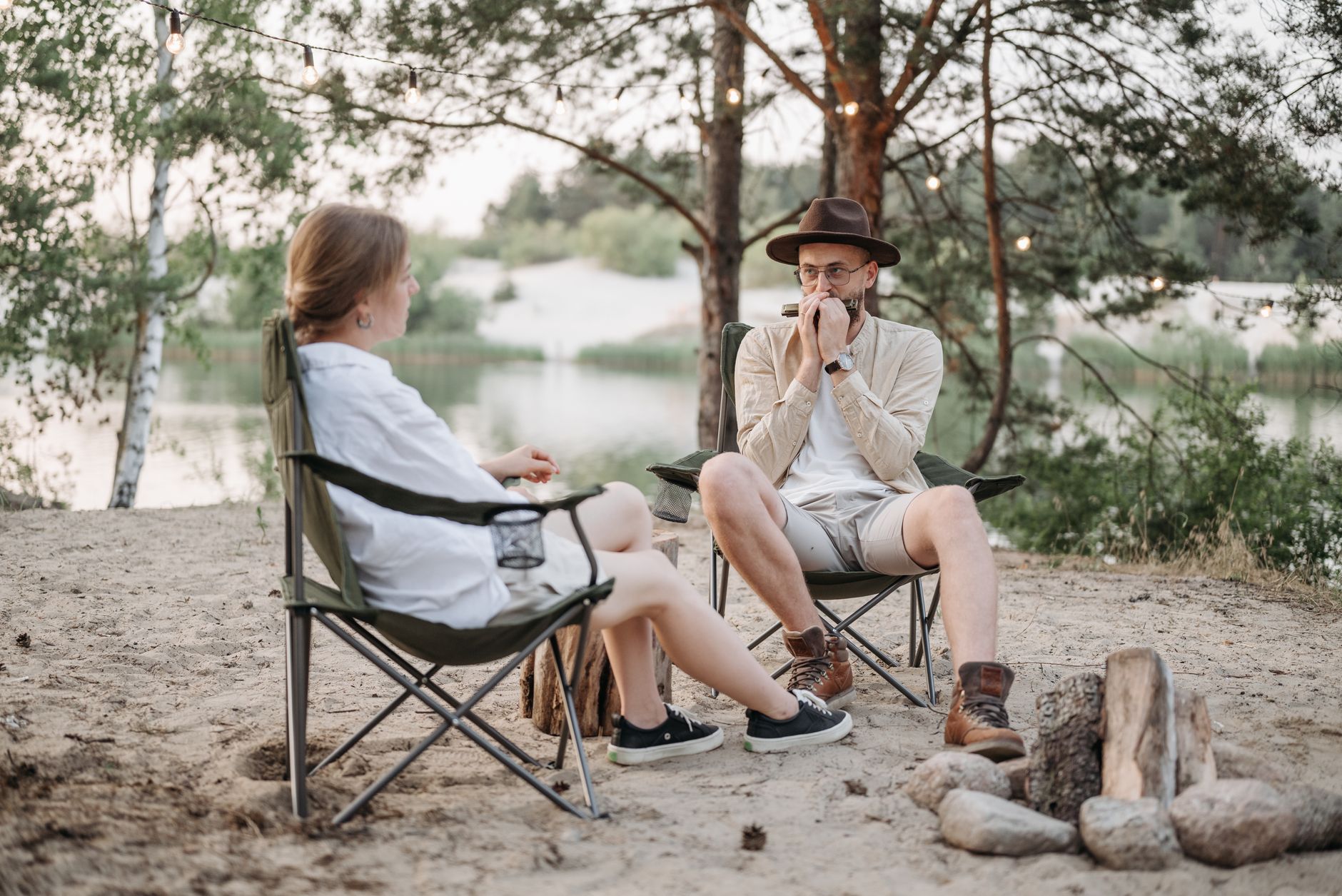 Best camping chair: folding chairs set up around a campfire